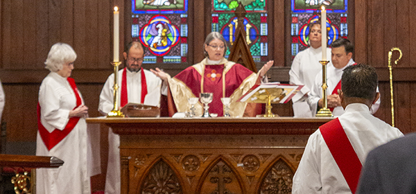 Bishop Lucinda Ashby celebrating the Eucharist with clergy at the altar
